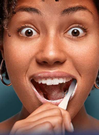 Woman using toothbrush